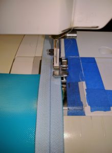 Blue Vinyl Zipper Half Being Stitched