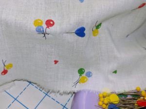 Putting pins through the fabric into the cap