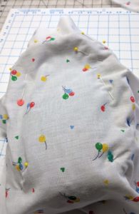 Pin it well to keep the fabric in place whilst you find the seams