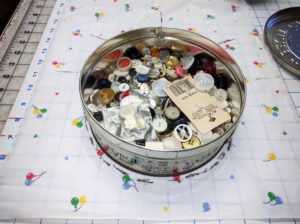 The inside of the fruit cake tin contains vintage buttons