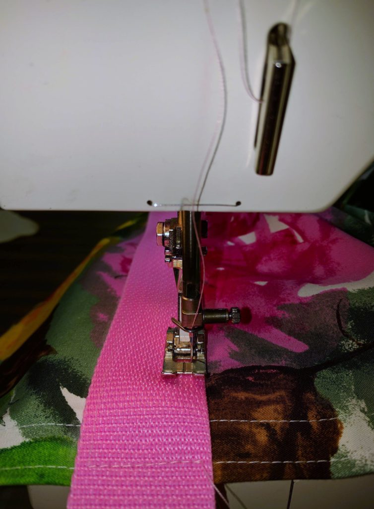 Stitch around the webbing to secure it to the tote